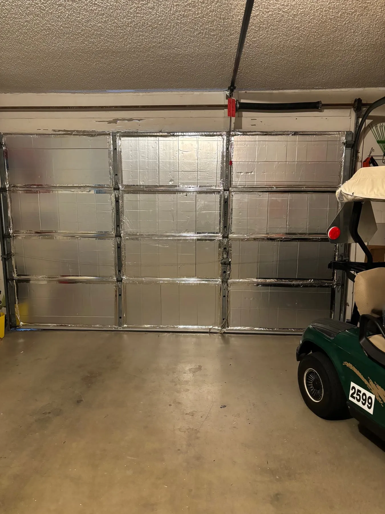 Garage door with insulated panels on every section