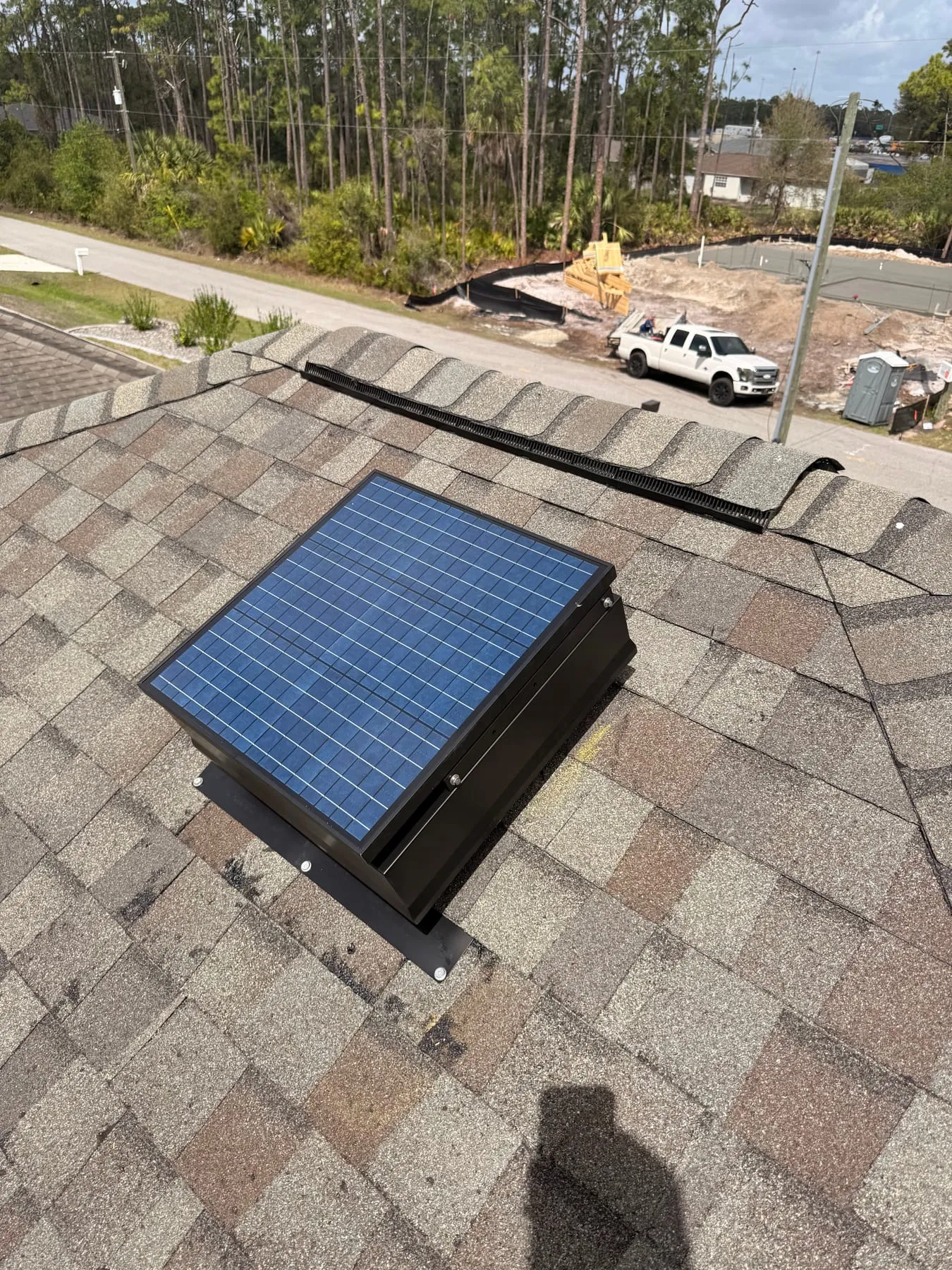 Solar attic fan installed on a shingle roof
